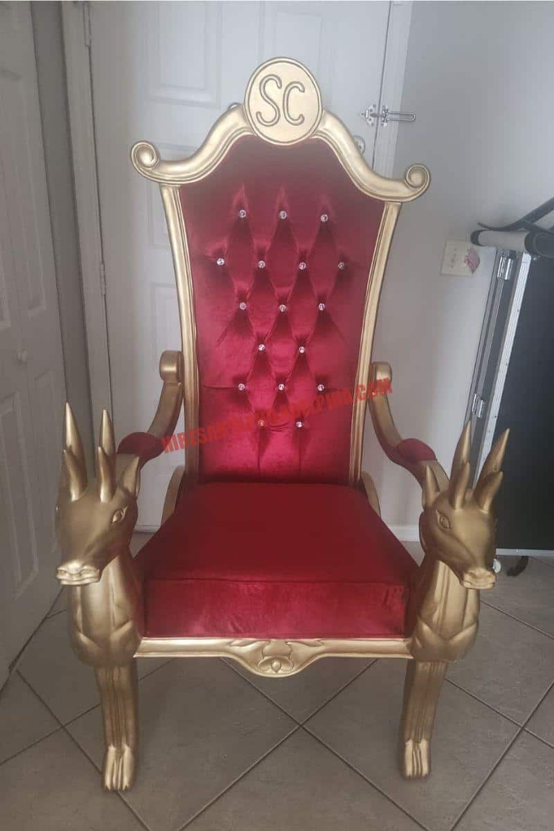 Santa chair photos in Philadelphia: empty gold chair with a red tufted back and gifts.
